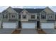 Three-unit townhome building with attached garages and neutral color palette at 1080 Cades Walk, Lawrenceville, GA 30045