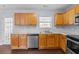 Kitchen with light wood cabinets, stainless steel appliances and dark flooring at 720 Hillandale Ln, Lithonia, GA 30058