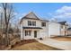 Two-story house with gray siding, dark gray door, and driveway at 6355 Akins Way, Cumming, GA 30041