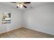 Bright bedroom with ceiling fan and a window overlooking the backyard at 308 Pine Cir, Bowdon, GA 30108