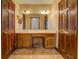 Main bathroom with double vanity and wood cabinets at 1060 River Cove Rd, Social Circle, GA 30025