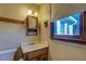 Small bathroom with single vanity and window at 1060 River Cove Rd, Social Circle, GA 30025