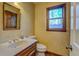 Powder room with single vanity and floral wallpaper at 1060 River Cove Rd, Social Circle, GA 30025