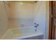 White tiled bathroom with a bathtub and shower at 1060 River Cove Rd, Social Circle, GA 30025