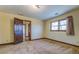 Bright bedroom featuring wood doors and carpet flooring at 1060 River Cove Rd, Social Circle, GA 30025
