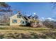 Side view of a yellow house with a large yard at 1060 River Cove Rd, Social Circle, GA 30025