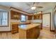 Bright kitchen features wood cabinets, an island, and stainless steel appliances at 1060 River Cove Rd, Social Circle, GA 30025