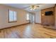 Living room with hardwood floors, brick fireplace, and large windows at 1060 River Cove Rd, Social Circle, GA 30025