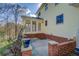 Cozy patio with brick accents and sunroom access at 1060 River Cove Rd, Social Circle, GA 30025