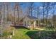 White shed with a metal roof in the backyard at 1060 River Cove Rd, Social Circle, GA 30025