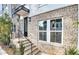 Townhome features a modern front entrance with brick accents and metal railing at 1923 Rogers Ct, Atlanta, GA 30318