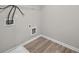 Bright laundry room with vinyl flooring and built-in shelving at 4267 Waxwing St, Buford, GA 30548