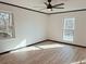 Bright bedroom with wood floors, ceiling fan, and large windows at 4756 Manly Ct, Stone Mountain, GA 30088