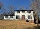 Two-story house with white siding, black shutters, and a red front door at 4756 Manly Ct, Stone Mountain, GA 30088