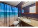 Clean bathroom with granite countertop and beach-themed shower curtain at 250 Windsor Way, Fairburn, GA 30213
