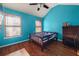 Bright bedroom with wood floors and a ceiling fan at 250 Windsor Way, Fairburn, GA 30213