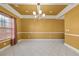 Dining room with tile floors, chandelier, and large window at 250 Windsor Way, Fairburn, GA 30213