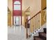 Elegant entryway with tile floors, high ceilings and a staircase at 250 Windsor Way, Fairburn, GA 30213
