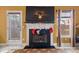 Fireplace with stockings and a large TV above at 250 Windsor Way, Fairburn, GA 30213