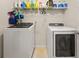 Laundry room with washer, dryer, and overhead storage at 250 Windsor Way, Fairburn, GA 30213
