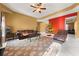 Living room with tiled floors, Christmas tree and comfortable seating at 250 Windsor Way, Fairburn, GA 30213