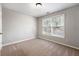 Well-lit bedroom with neutral walls, carpet, and a window at 2020 Austin Park Cir, Decatur, GA 30032