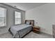 Simple bedroom with gray bedding, and ample natural light at 3957 Knox Park Ovlk, Duluth, GA 30097