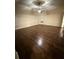 Large bedroom with dark hardwood floors and ceiling fan at 7940 White Oak Loop, Lithonia, GA 30038