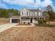 Two-story house with a stone facade, attached garage, and front porch at 3170 Victoria Ridge Ct, Loganville, GA 30052