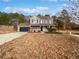 Two-story house with a stone facade, attached garage, and front porch at 3170 Victoria Ridge Ct, Loganville, GA 30052