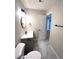 Modern bathroom with gray vanity, marble-look floors, and updated fixtures at 2759 Kerri Pl, Lithia Springs, GA 30122