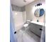 Updated bathroom features a gray vanity, marble-look floors, and a bathtub at 2759 Kerri Pl, Lithia Springs, GA 30122