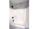 Clean bathroom with a white bathtub/shower combo and gray wall tile at 2759 Kerri Pl, Lithia Springs, GA 30122