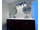 Double vanity bathroom with modern lighting and mirrors at 2759 Kerri Pl, Lithia Springs, GA 30122