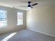 Well-lit bedroom with neutral walls, carpet, and two windows at 2759 Kerri Pl, Lithia Springs, GA 30122