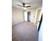 Bright bedroom featuring a ceiling fan, beige carpet and a walk-in closet at 2759 Kerri Pl, Lithia Springs, GA 30122