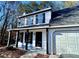 Renovated home exterior with white siding, black accents, and a two car garage at 2759 Kerri Pl, Lithia Springs, GA 30122
