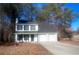 White two-story house with black window trim and a two-car garage at 2759 Kerri Pl, Lithia Springs, GA 30122