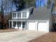 Two-story house with white siding, black accents, and two-car garage at 2759 Kerri Pl, Lithia Springs, GA 30122