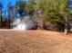 Side view of a charming two-story house nestled in woods at 2759 Kerri Pl, Lithia Springs, GA 30122