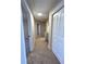 Upstairs hallway with beige carpet, doors to bedrooms, and a linen closet at 2759 Kerri Pl, Lithia Springs, GA 30122