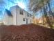 Rear view of a two-story house, showcasing its white siding and wooded setting at 2759 Kerri Pl, Lithia Springs, GA 30122