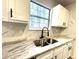 Kitchen features a double sink, granite countertops, and a modern faucet at 2759 Kerri Pl, Lithia Springs, GA 30122