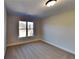 Well-lit bedroom with carpet flooring and large window at 208 Serendipity Way, Dallas, GA 30157