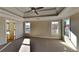 Main bedroom with tray ceiling, carpet flooring, and ensuite bathroom access at 208 Serendipity Way, Dallas, GA 30157