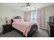 Bedroom with dark wood frame bed and pastel decor at 175 Barclay Dr, Mcdonough, GA 30252