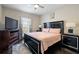 Bedroom with a king-size bed and dark wood furniture at 175 Barclay Dr, Mcdonough, GA 30252