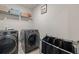 Laundry room with washer, dryer, and shelving at 175 Barclay Dr, Mcdonough, GA 30252