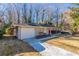 Front view of a ranch home with a white garage door and driveway at 2330 Dorsey Ave, Atlanta, GA 30344