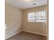 Simple bedroom with neutral walls and carpet, featuring two windows at 3152 Bay St, Scottdale, GA 30079